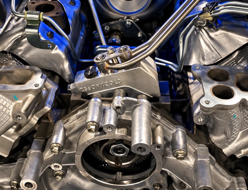 High-pressure fuel pump mounted in the valley of a diesel V8.